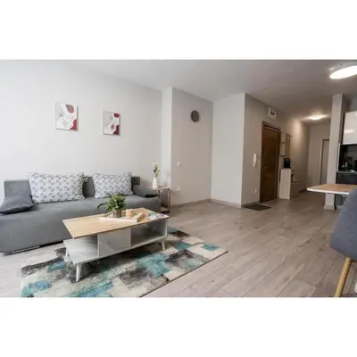 a living room with a couch and a table at Modern 1BR Comfort in Oborishte with Private Parking in Sofia