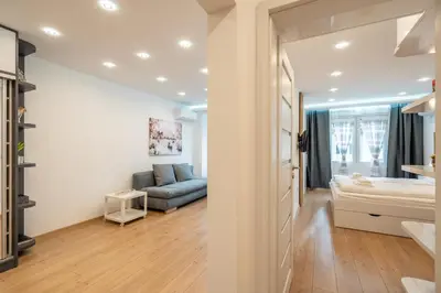 a living room with a bed and a couch at Zenith Apartment in Sofia