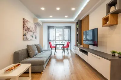 a living room with a couch and a table at Zenith Apartment in Sofia
