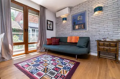 a living room with a couch and a rug at Central 1-bedroom Apartment in Plovdiv