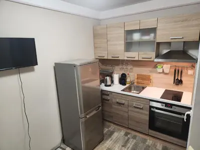 a kitchen with a stainless steel refrigerator and a sink at luxury two bedroom Crown Apartament in Pravets