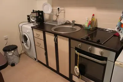 a kitchen with a sink and a washing machine at Apartment Atanasov - Pamporovo in Pamporovo