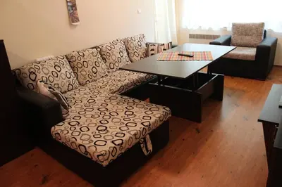 a living room with a couch and a table at Apartment Atanasov - Pamporovo in Pamporovo
