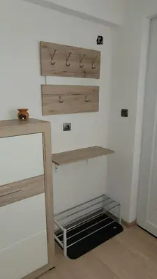 a room with wooden shelves on the wall at Strumyani tiny flat in Sandanski
