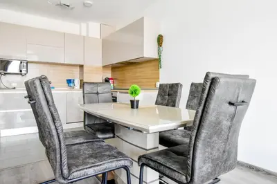a kitchen with a table and chairs at Nomad Friendly Modern Complex Next to Metro in Sofia