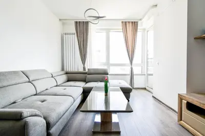 a living room with a couch and a table at Nomad Friendly Modern Complex Next to Metro in Sofia