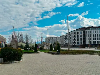 a parking lot in a city with tall buildings at Nomad Friendly Modern Complex Next to Metro in Sofia