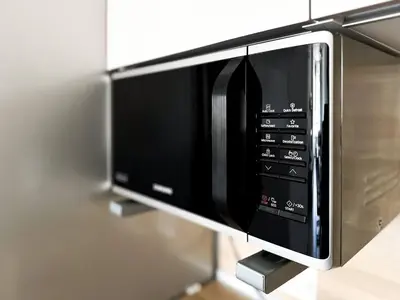 a microwave oven is attached to a wall at Nomad Friendly Modern Complex Next to Metro in Sofia