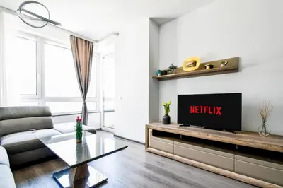 a living room with a couch and a tv at Nomad Friendly Modern Complex Next to Metro in Sofia
