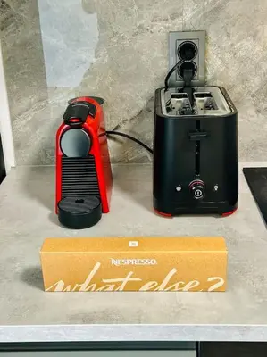 a red and black toaster and a box on a counter at 15% Discount! Limited Time in Sofia