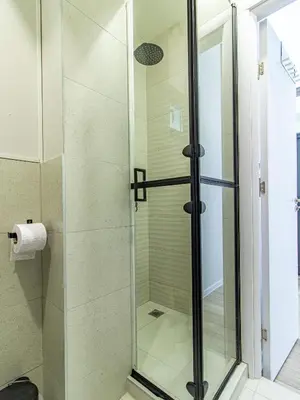 a shower with a glass door in a bathroom at Stay Central: Urban Studio Gem in Sofia