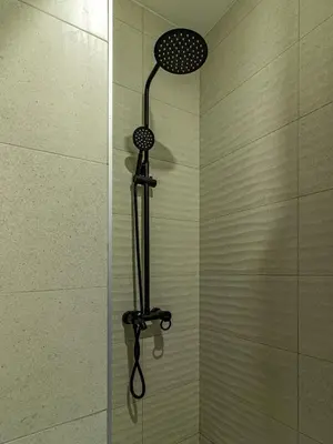 a shower with a shower head in a shower at Stay Central: Urban Studio Gem in Sofia