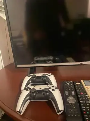 a video game controller sitting on a table next to a tv at New Two Bedroom apartment with balcony in Sofia