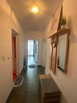 a room with a hallway with a table and a mirror at New Two Bedroom apartment with balcony in Sofia