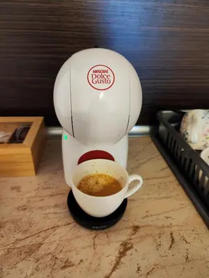 a coffee maker sitting on a counter with a cup of coffee at Panorama Stoykite Orpheus in Stoykite
