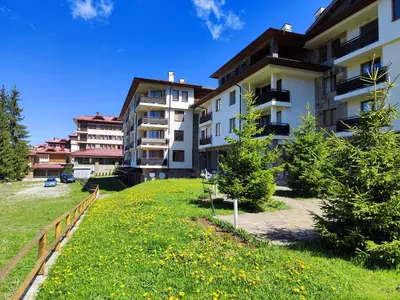 a row of apartment buildings with a green yard at Panorama Stoykite Orpheus in Stoykite