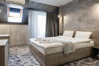a bedroom with a large bed and a window at RCR Einstein studios in Sofia