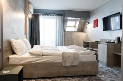 a bedroom with two beds and a television in it at RCR Einstein studios in Sofia