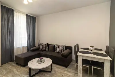 a living room with a couch and a table at Stylish 2 BDR Apartment at an Excellent Location in Sofia