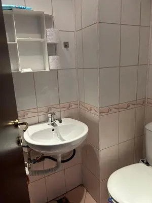 a bathroom with a sink and a toilet at Apartament Armada Bansko in Bansko