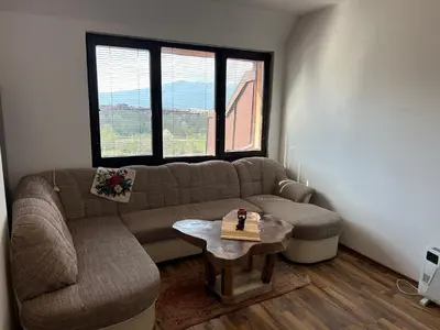 a living room with a couch and a table at Apartament Armada Bansko in Bansko