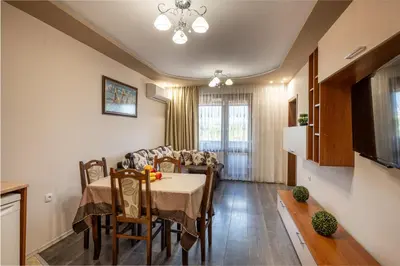 a kitchen and dining room with a table and chairs at Апартамент за гости ВениАн in Velingrad