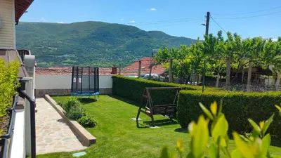 a garden with a swing and a playground at Guest House Saint George in Vukovo