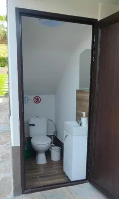 a bathroom with a toilet and a sink at Guest House Saint George in Vukovo