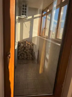a door view of a room with a stack of logs at Apartment Danik River Glaznel in Bansko