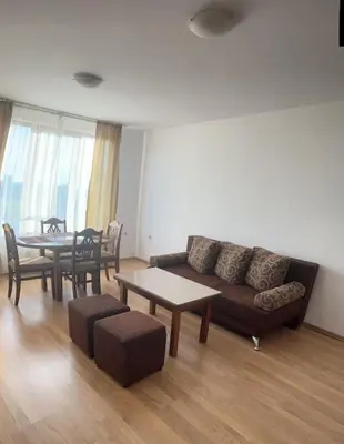 a living room with a couch and a table at Apartment Danik River Glaznel in Bansko