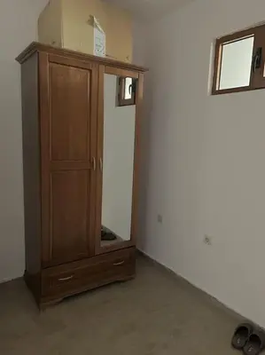 a wooden cabinet with a mirror in a room at Apartment Danik River Glaznel in Bansko