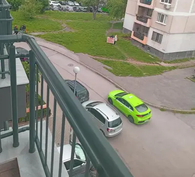 two cars parked in a parking lot on a balcony at Alis Savana in Sofia