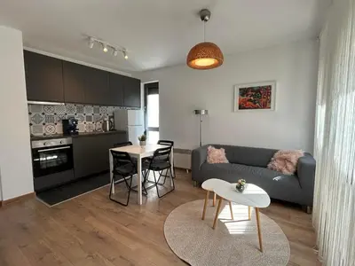 a living room with a couch and a table at Idea Apartment in Sofia
