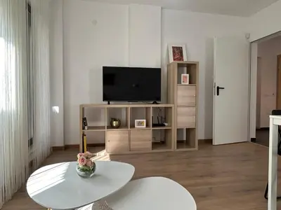a living room with a tv and a coffee table at Idea Apartment in Sofia