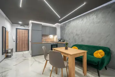 a living room with a green couch and a table at Cozy Homes 4 in Sofia
