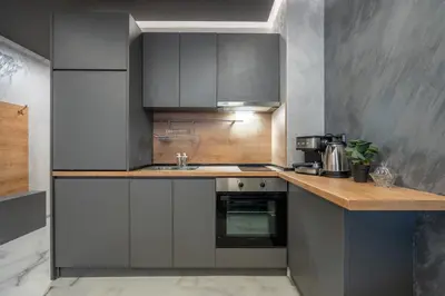 a kitchen with gray cabinets and a sink at Cozy Homes 4 in Sofia