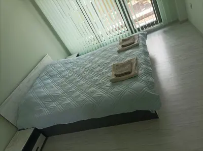 a bedroom with a bed with two pillows on it at Мариана in Plovdiv