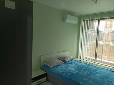 a small bedroom with a bed and a window at Мариана in Plovdiv