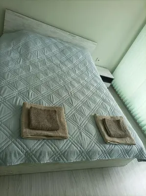 a bed with two pillows on it in a room at Мариана in Plovdiv