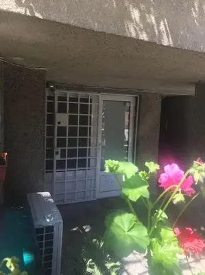 a door to a building with flowers in front of it at Studio for guests Catherine in Sofia