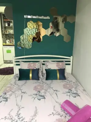 a bedroom with a bed with a flowery wall at Studio for guests Catherine in Sofia