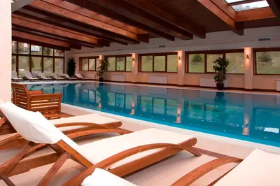 a swimming pool with lounge chairs and a swimming pool at Cozy apartment in luxury SPA resort St Ivan Rilski Bansko -free wellness & parking- in Bansko