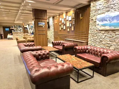 a waiting room with leather couches and tables at Cozy apartment in luxury SPA resort St Ivan Rilski Bansko -free wellness & parking- in Bansko
