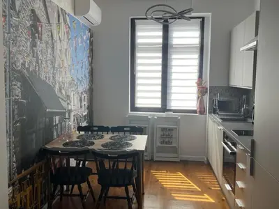 a kitchen with a table and chairs in a room at Diva Kapana 2BDR Apartment with parking in Plovdiv
