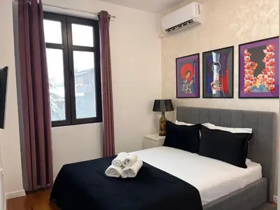 a bedroom with a bed with towels on it at Diva Kapana 2BDR Apartment with parking in Plovdiv