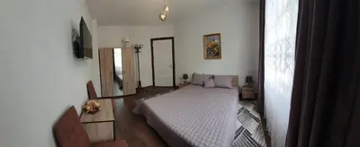 a bedroom with a white bed in a room at АПАРТАМЕНТ ЮЛИЯ ДЕЛУКС II in Velingrad