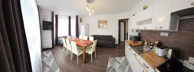 a kitchen and dining room with a table and chairs at АПАРТАМЕНТ ЮЛИЯ ДЕЛУКС II in Velingrad