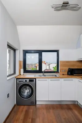 a kitchen with a washing machine and a window at Feel at Home - Central 2BD Flat with Parking by Flat Mаnager in Sofia