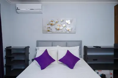 a bedroom with a bed with purple pillows at Feel at Home - Central 2BD Flat with Parking by Flat Mаnager in Sofia