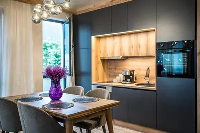 a kitchen with a table with a purple vase on it at Lux Apart Karlovo 1 in Karlovo